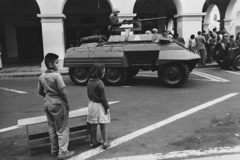 Lima, Perù, 1963, I soldati occupano le piazze (I soldati occupano le piazze con i carri armati e i bambini aspettano la violenza che non arriva. Nel Paese degli Incas un colpo di Stato all’anno). Stampa originale d’epoca alla gelatina ai sali d’argento, 23,5 x 35,5 cm, archivio Cascio, Roma